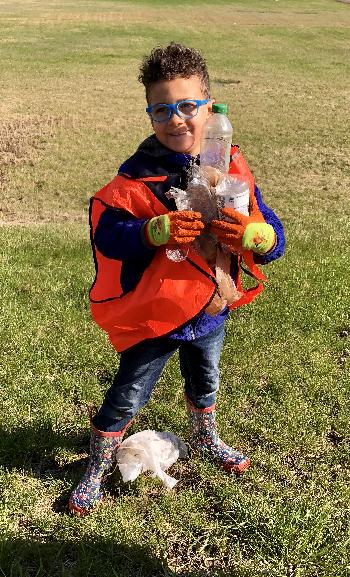 Child helping pick up trash