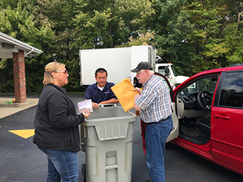 assisting members with shredding assisting members with shredding